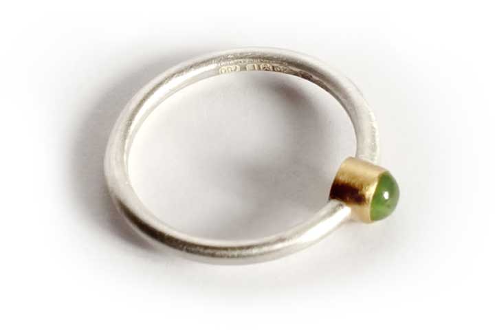 Jade cabochon set in 18 carat gold and sterling silver