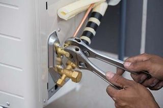 Installation of Air Conditioner and Worker Connects Copper Pipe — Air Conditioning in Saginaw, MI