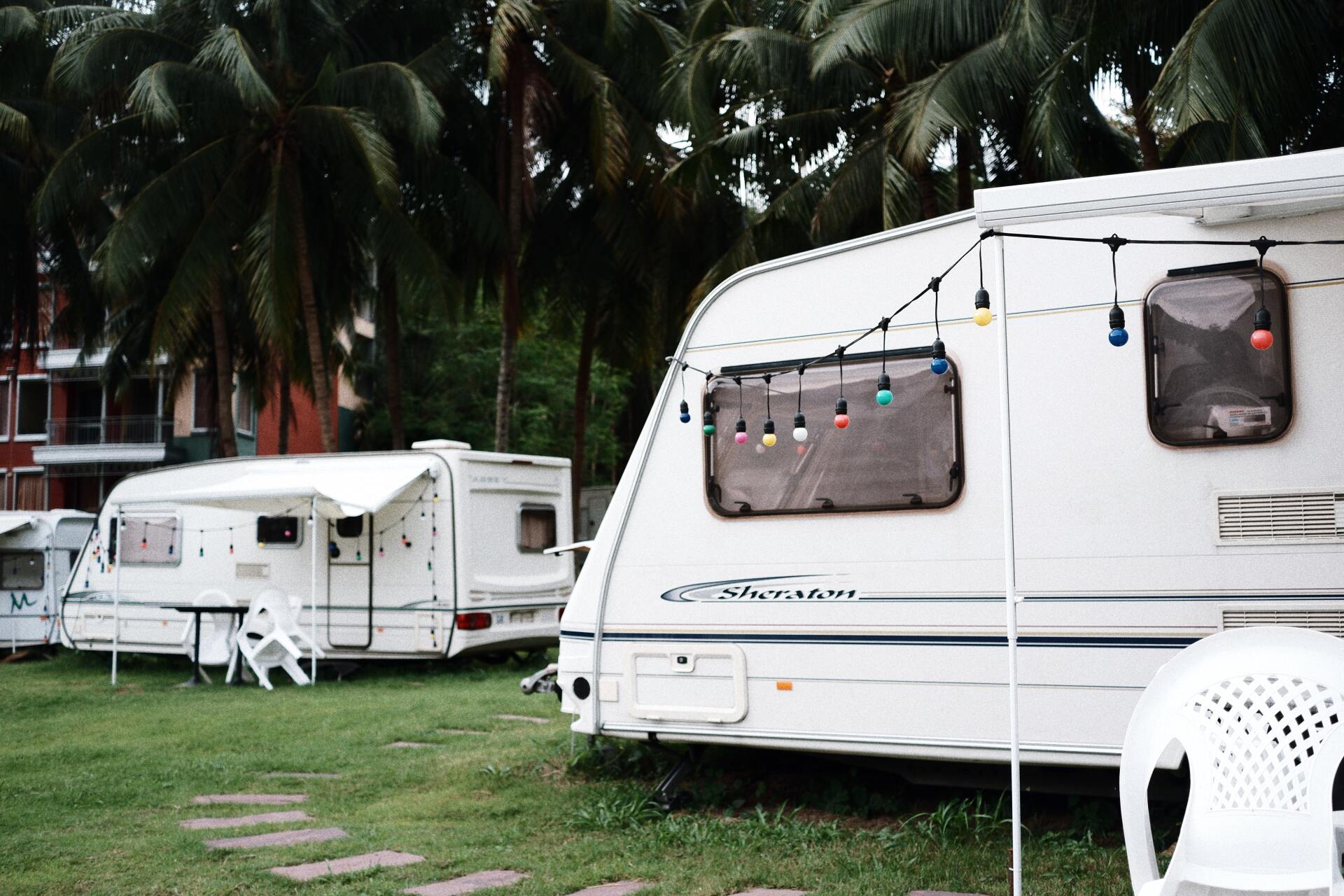 Caravan in campaign ground with coloured festoon lighting and an EWOF