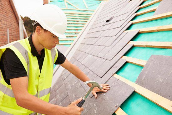 Construction Worker Layering Slate Tiles — Building Remodeling & Repair Contractors in Easton, PA Construction Worker Layering Slate Tiles — Building Remodeling & Repair Contractors in Easton, PA