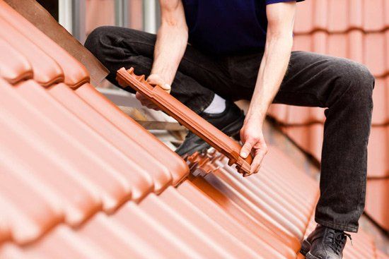 Tiler Covering Roof — Building Remodeling & Repair Contractors in Easton, PA Tiler Covering Roof — Building Remodeling & Repair Contractors in Easton, PA