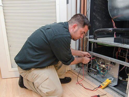 HVAC Contractors — Man Repairing HVAC — Albany, GA HVAC Contractors — Man Repairing HVAC — Albany, GA