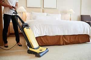 Man Moping the floor — house cleaning in Greeley, CO Man Moping the floor — house cleaning in Greeley, CO