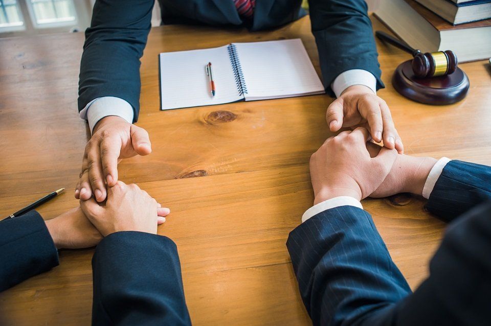 Business people at table with paperwork