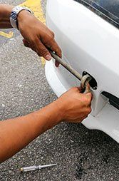 Roadside Assistance — Man Putting Tow in Car in Whitehall, PA