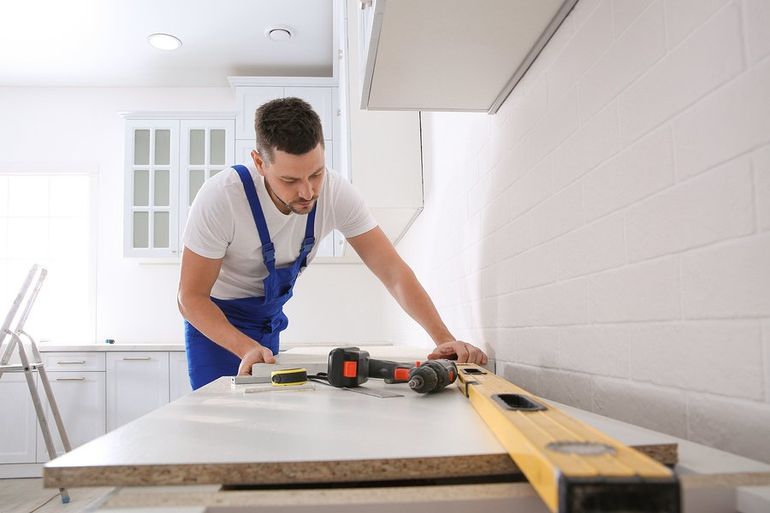 a handyman installing kitchen countertop