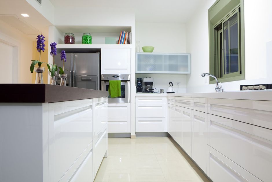 a kitchen room with white flooring and tops