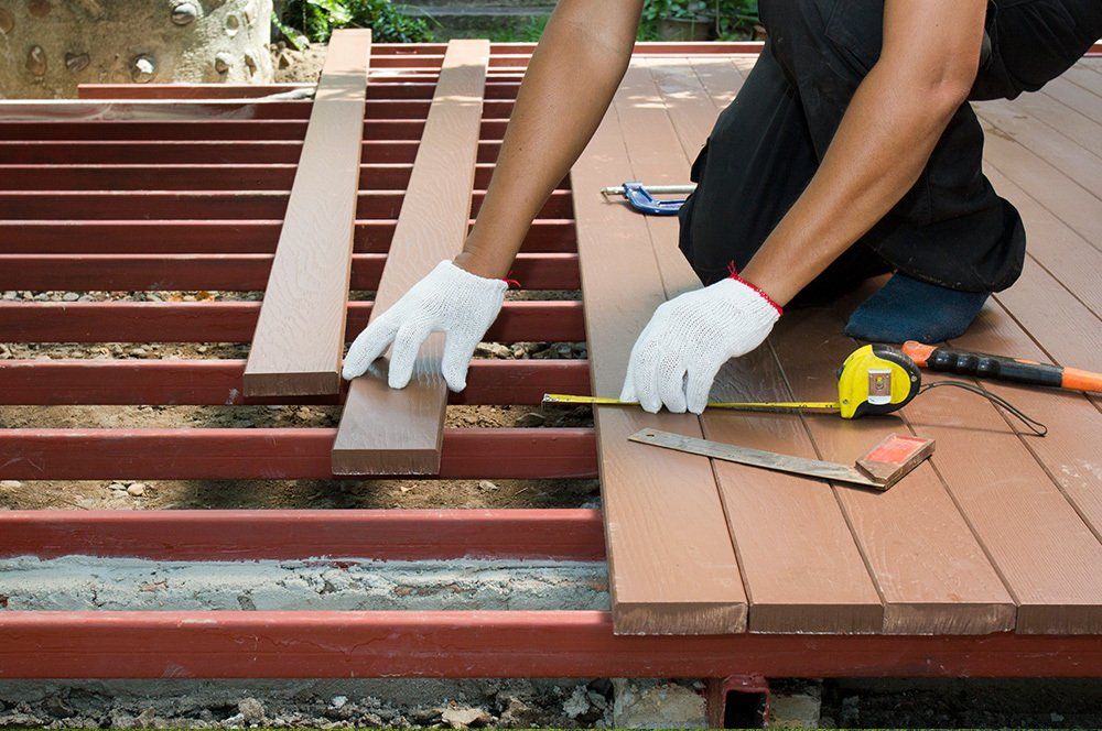 Carpenter Working on Deck — Denver, CO — Adams Lumber Company Carpenter Working on Deck — Denver, CO — Adams Lumber Company