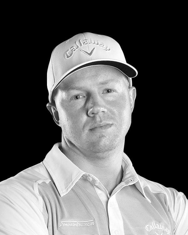 A black and white photo of a man wearing a hat and a shirt.