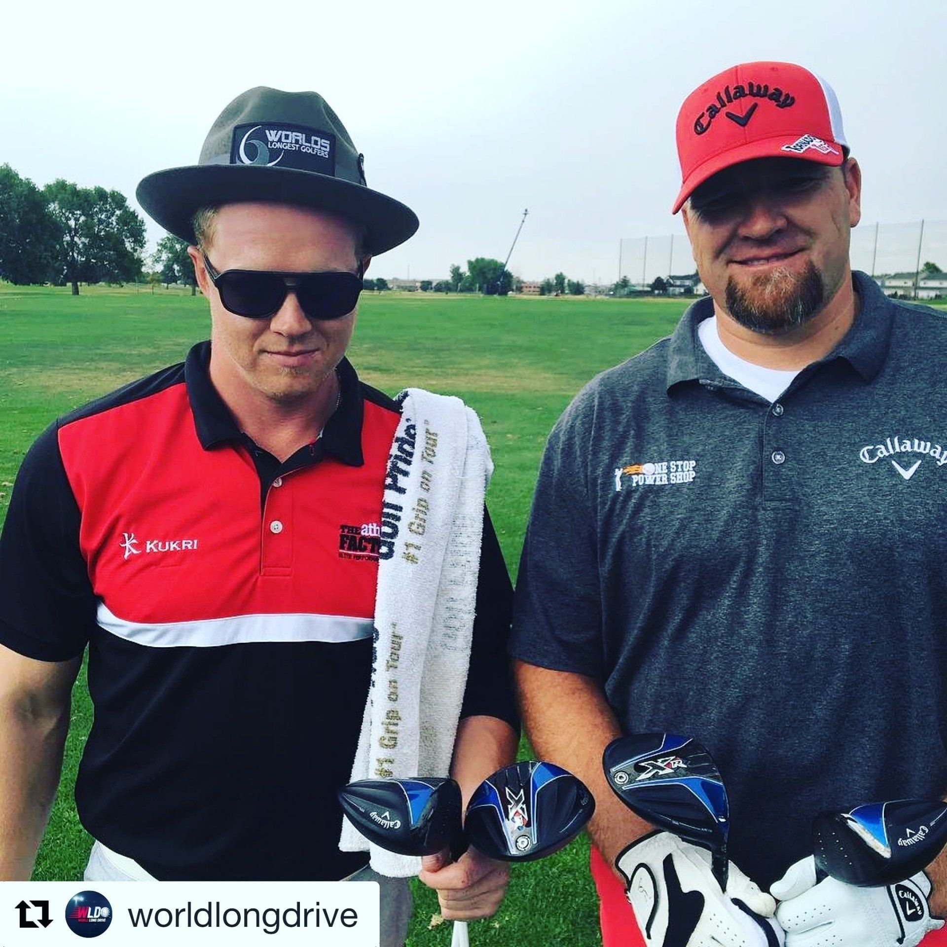 Two men standing next to each other on a golf course holding golf clubs
