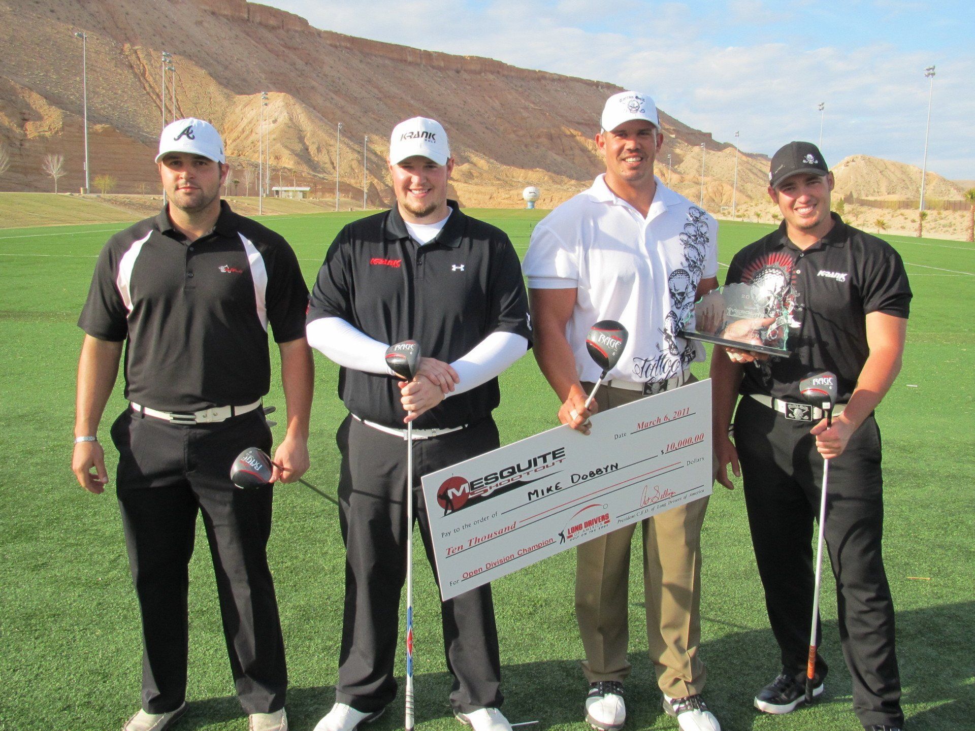 A group of men holding golf clubs and a cheque that says cobra on it