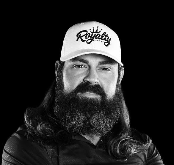 Man with long hair and beard wearing a white 