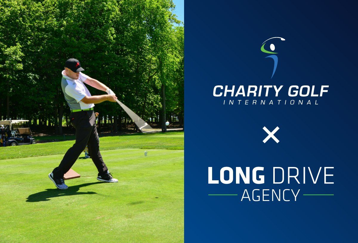 A man is swinging a golf club on a golf course.