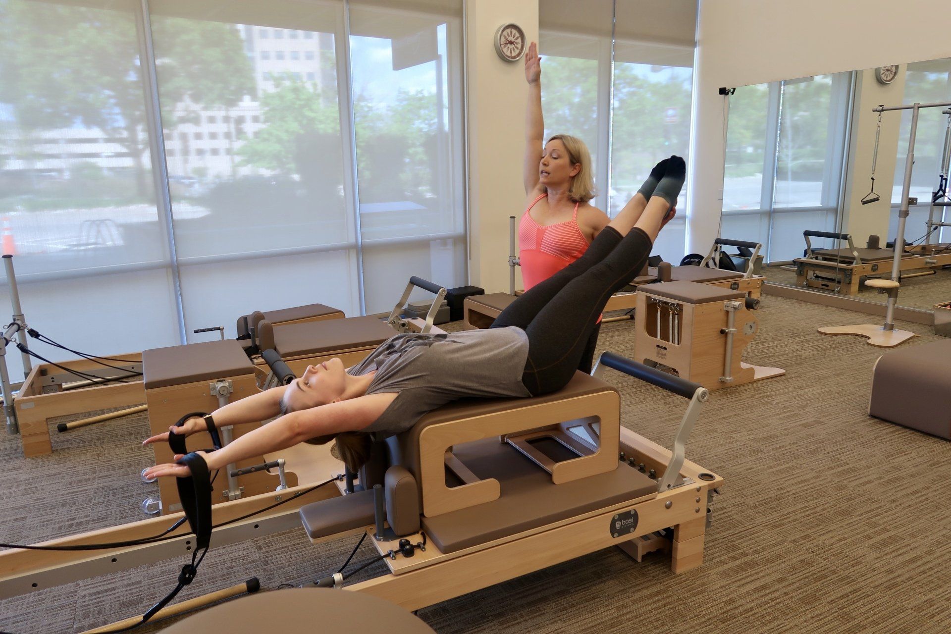 a girl performing basi pilates teacher training exercise