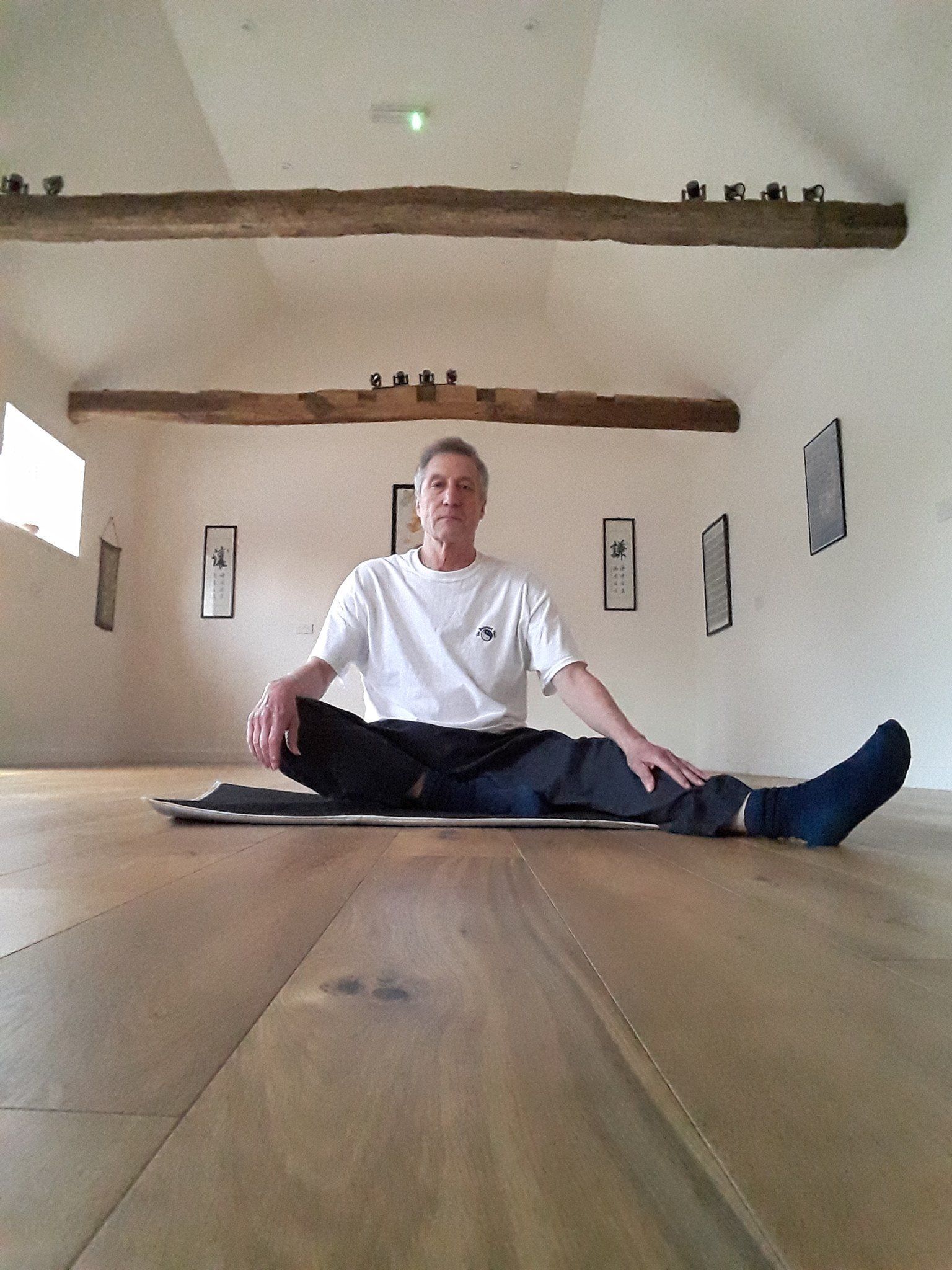 The Balanced Path At The Tai Chi Studio instructor Dave in sitting down, leg out position