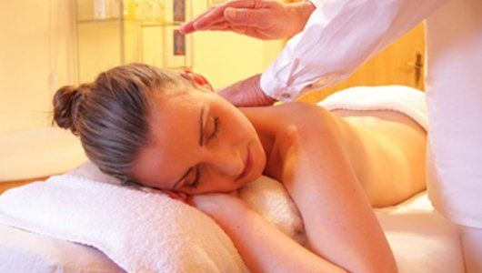 A woman is laying on a massage table getting a massage.