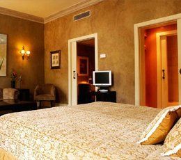 A hotel room with a large bed and a flat screen tv