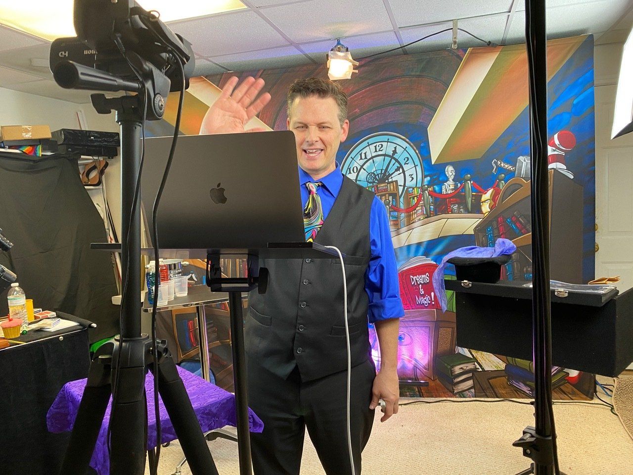 Magician Ken Scott waves hello to virtual audience