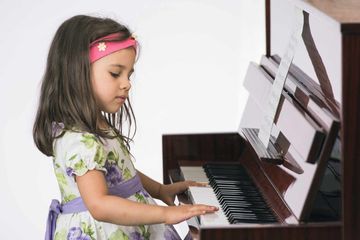 little girl playing the piano