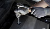 man installing car part