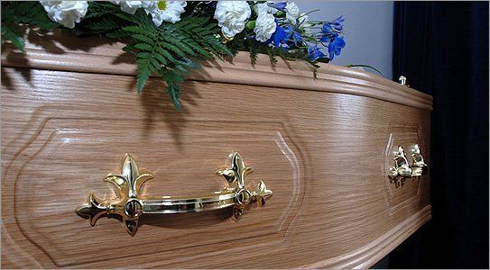 A coffin with flowers on top