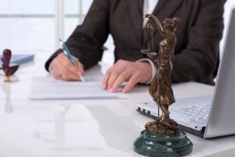 Man signing a contract — Law Office in Peoria, IL Man signing a contract — Law Office in Peoria, IL
