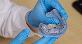 Doctor holding a biocompatible 3d printed transparent surgical guides