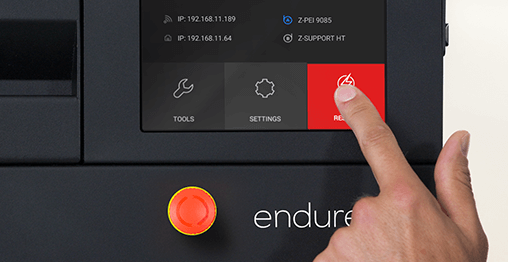 Engineer preesing an intuitive touch screen on Zortrax Endureal industrial FDM or FFF 3D printer