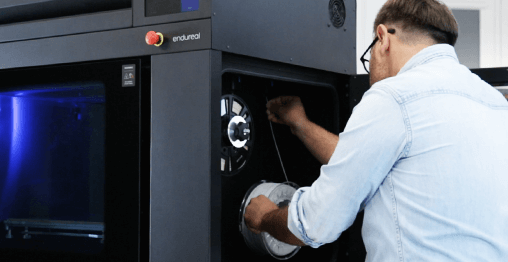 Engineer perform maintenance on Zortrax Endureal industrial FDM or FFF 3D printer