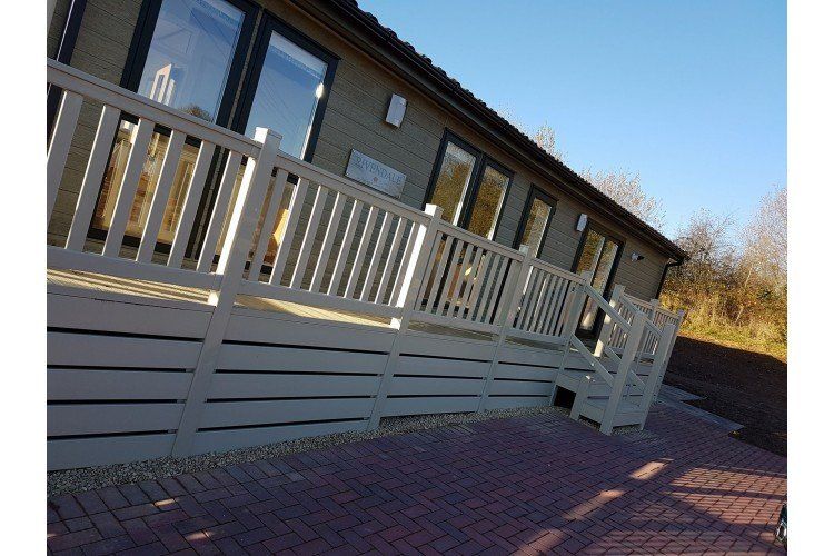 A house with a white railing on the side of it