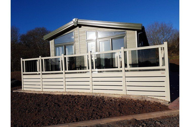 A house with a large deck and a fence around it
