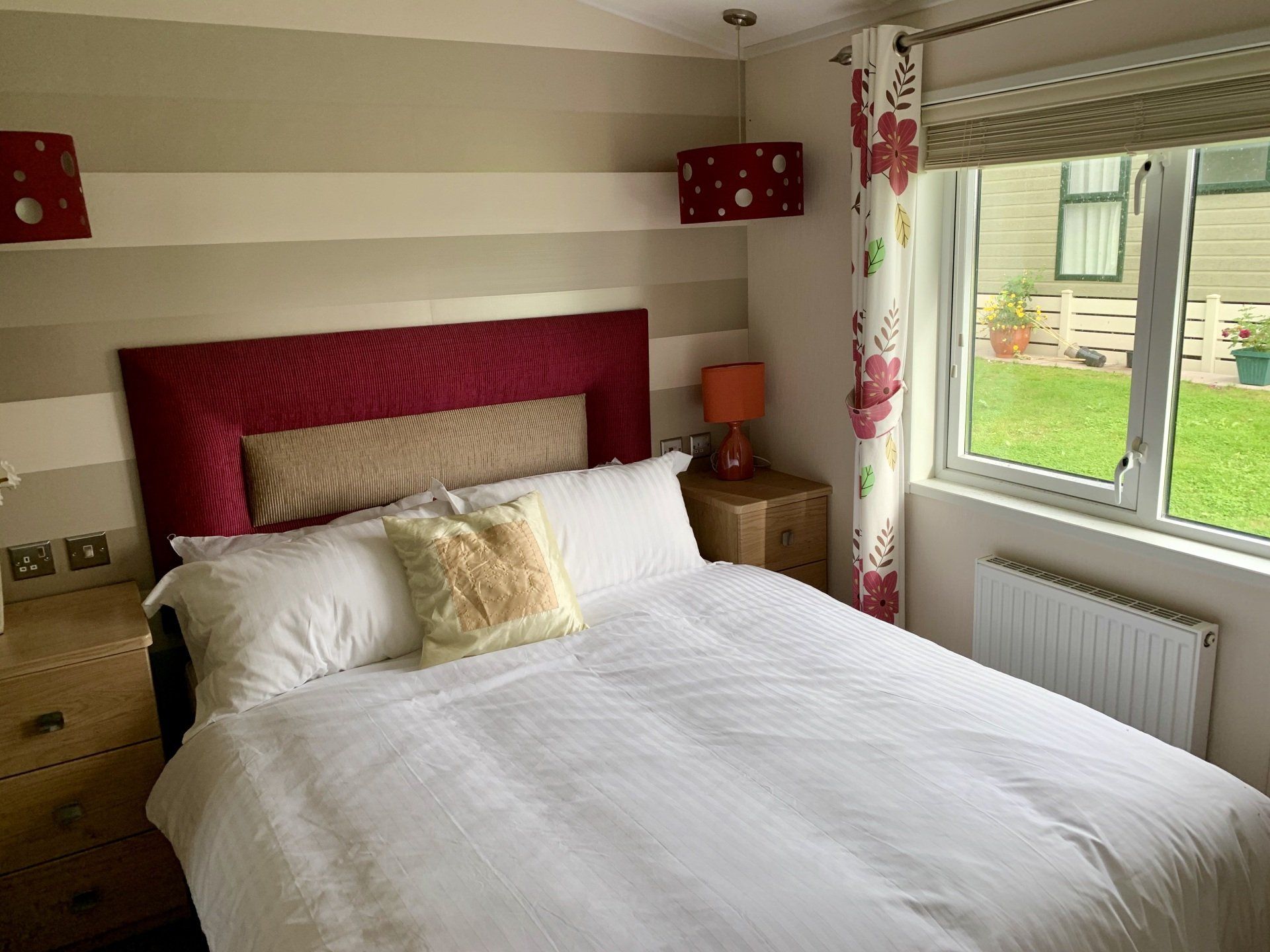 A bedroom with a large bed and a window.