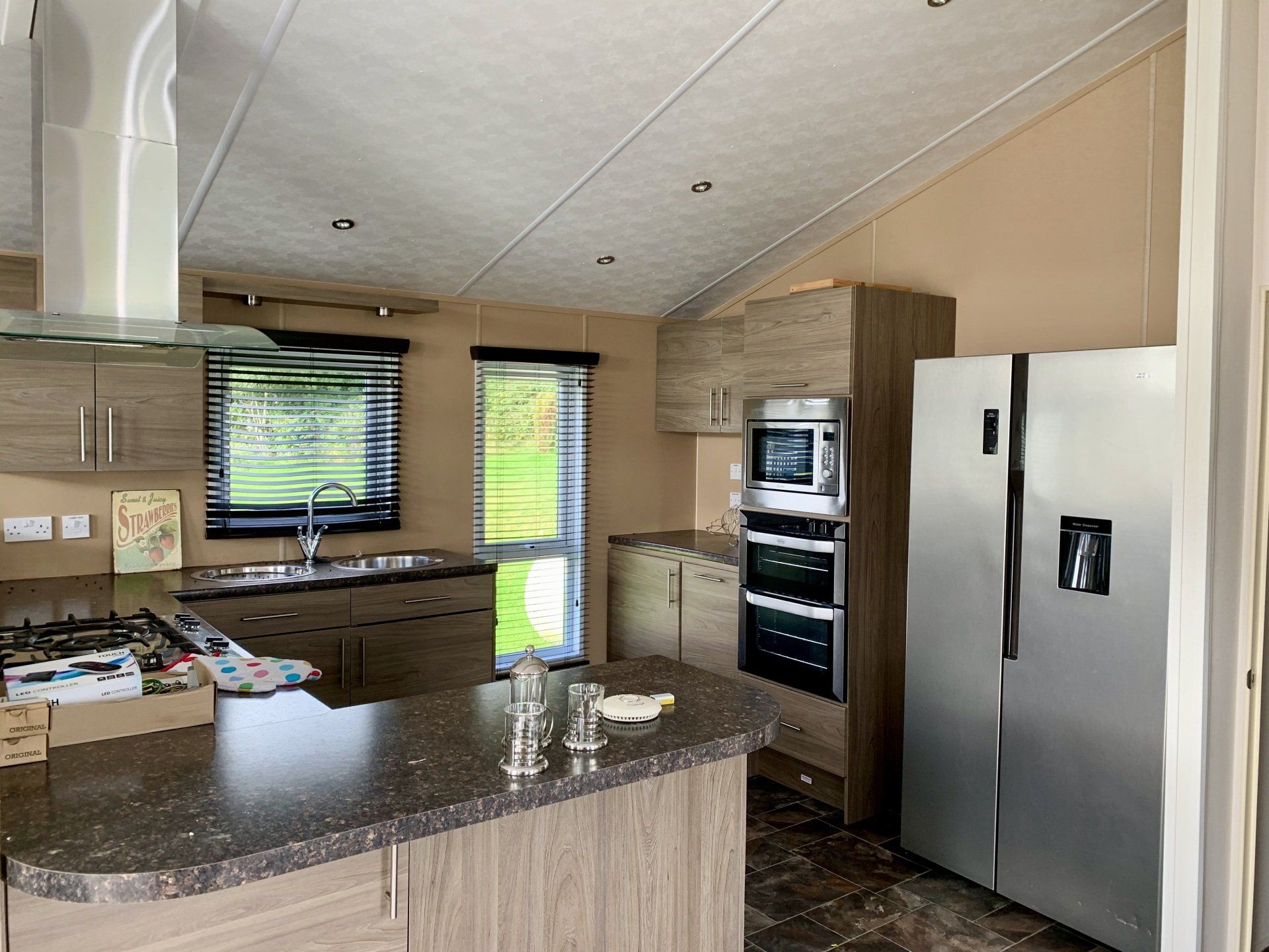 A kitchen with stainless steel appliances and a refrigerator.