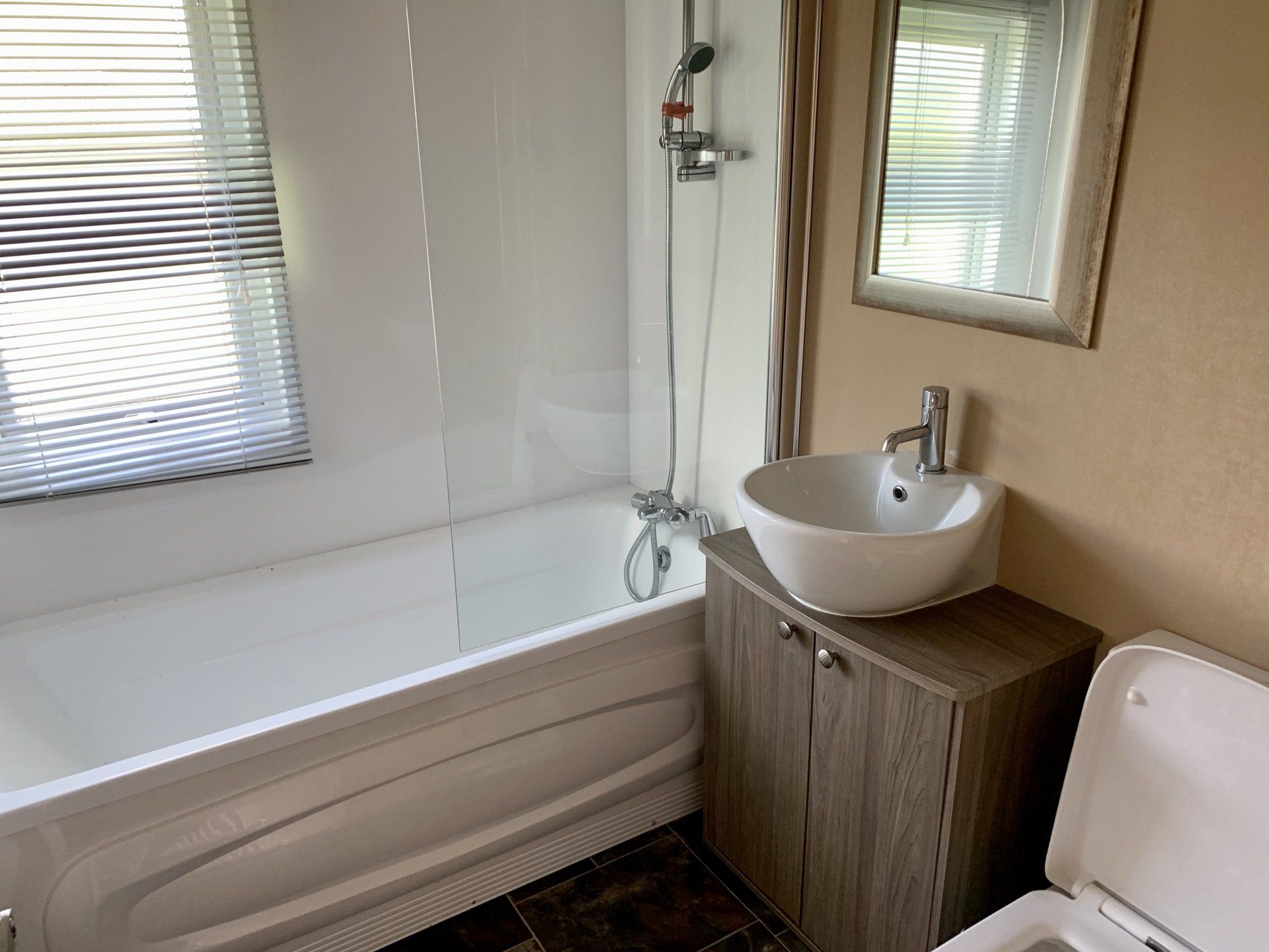 A bathroom with a sink , toilet and bathtub.