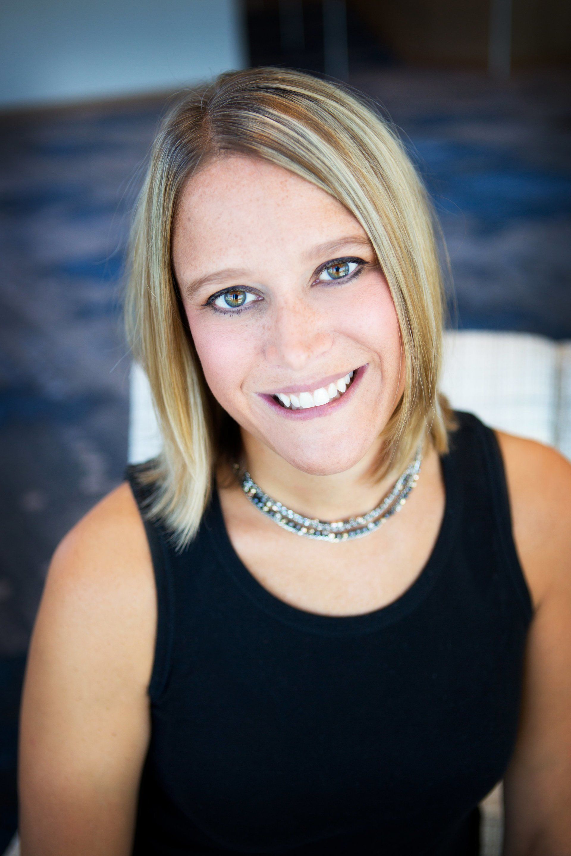 Woman smiling, possibly an advocate or panelist in a discussion.