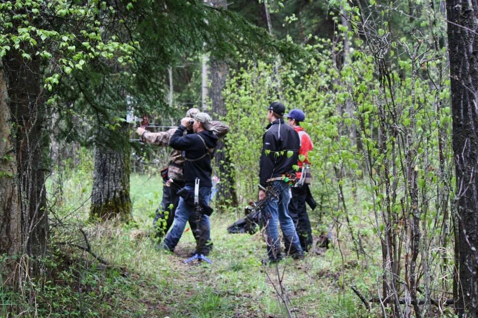 A group of people are standing in the middle of a forest.