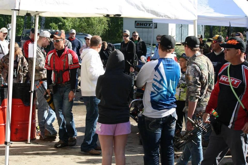A group of people are gathered under a tent.