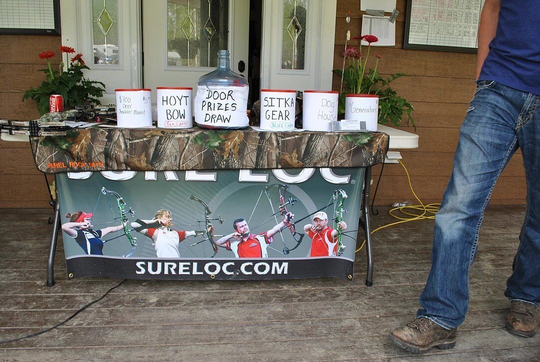A man standing in front of a table that says sureloc.com
