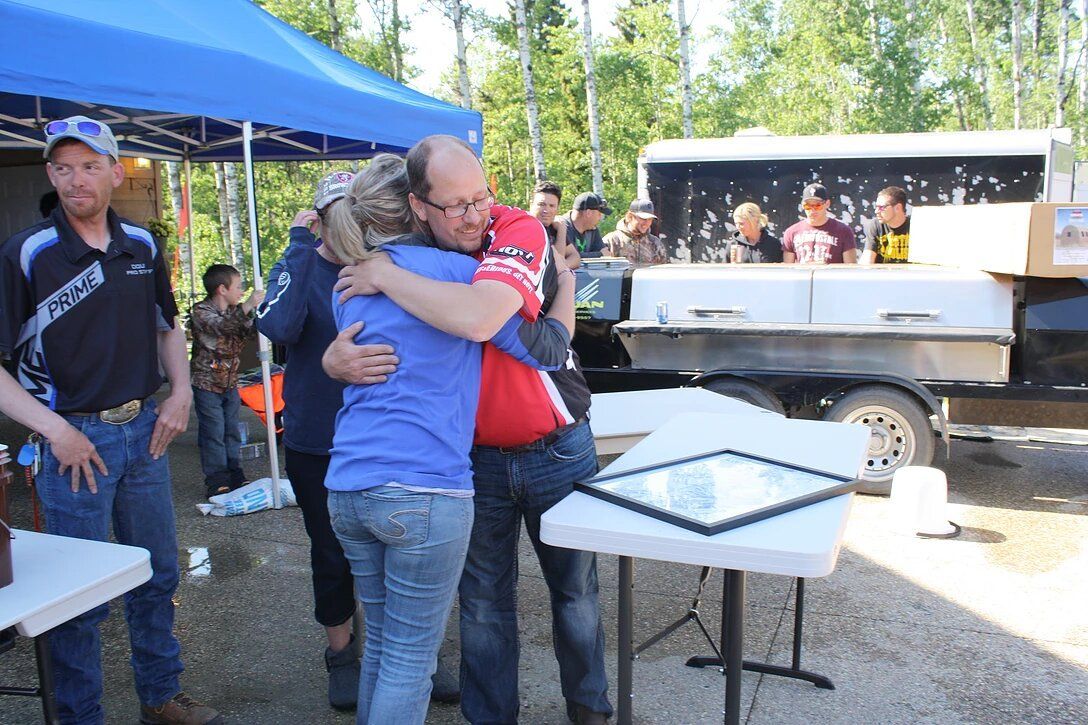 A man is hugging a woman in front of a group of people