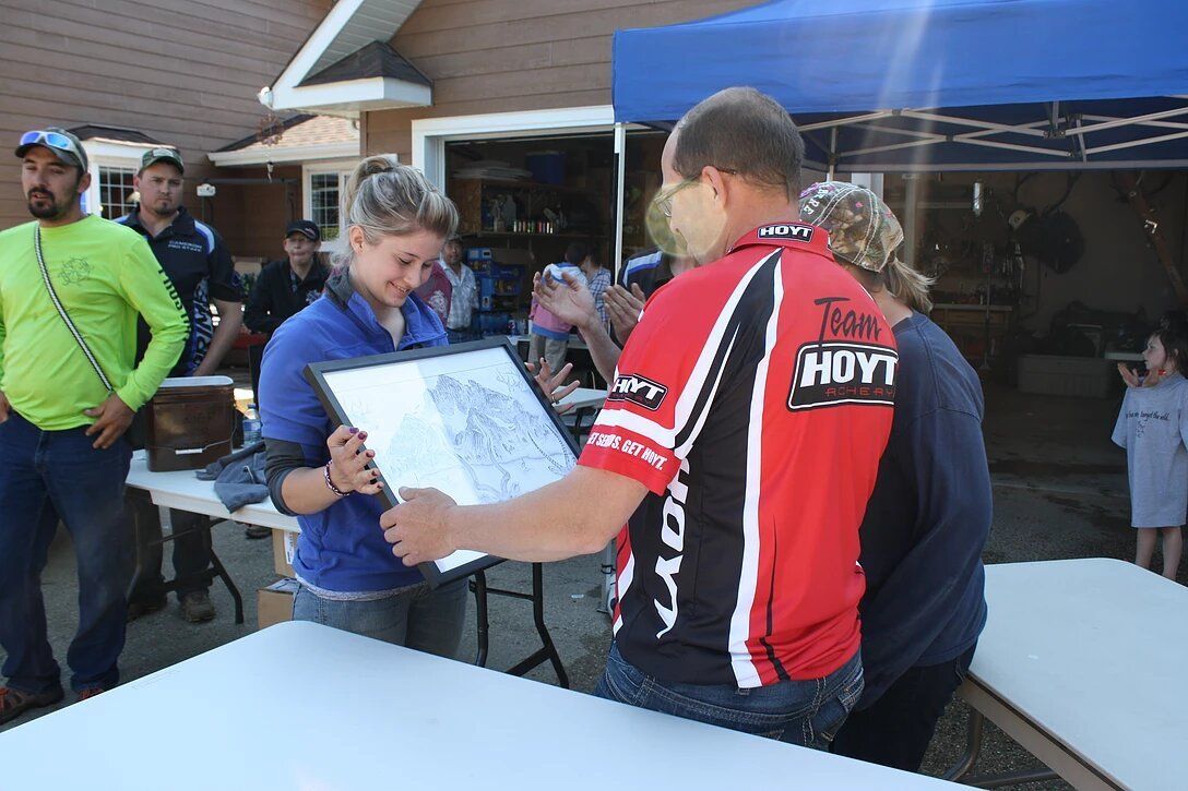 A man in a red shirt that says team ndy on it