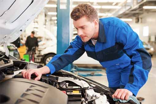 Mechanic Repairing a Car — Bro Muffler & Auto Repair in Huntington Beach, CA Mechanic Repairing a Car — Bro Muffler & Auto Repair in Huntington Beach, CA