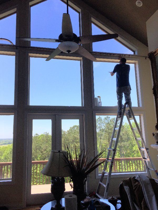 Heat Rejecting window tint in Wetumpka AL — SPF Technician Installing Tint to Glass windows in Wetumpka, AL