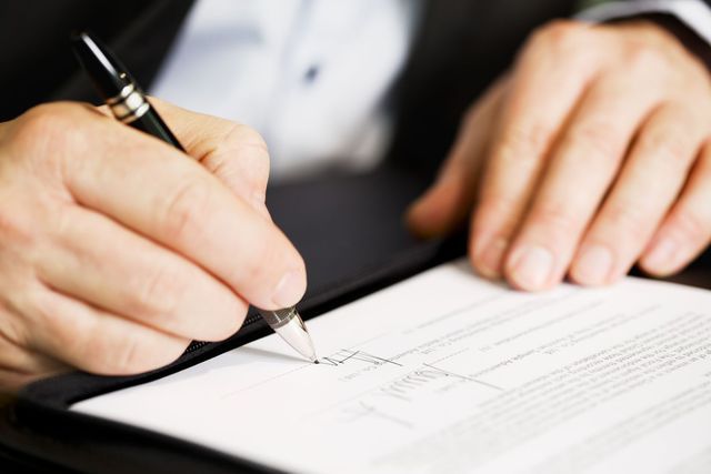 Signing papers at a law office in High Point, NC