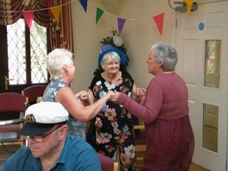 a carer comforting an elderly lady