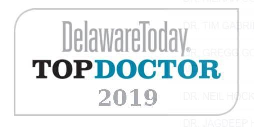 Delaware Today Top Doctor 2019 logo with dark blue and black text in a gray rounded rectangle.