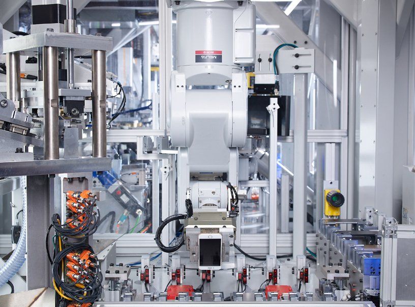 A robot is working on a machine in a factory.