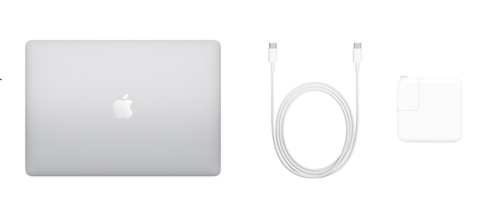 A silver MacBook, a white charging cable, and a white power adapter arranged on a plain background.