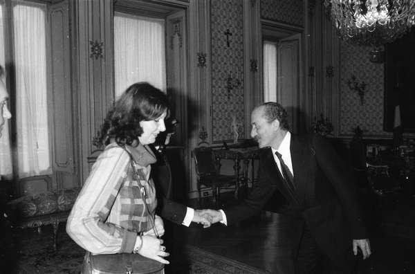 Un uomo e una donna si stringono la mano in una stanza.