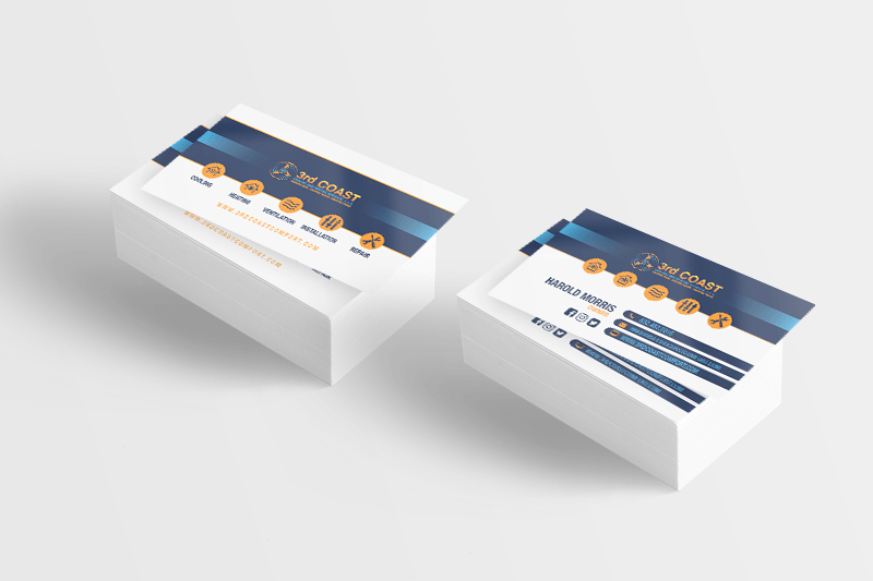 Two stacks of white business cards with blue and gold designs.