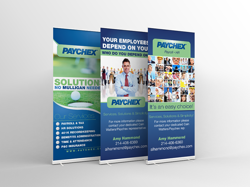 Three Paychex roll-up banners with company logo. One shows a golf course, another a businessman, and the last a collage of people.